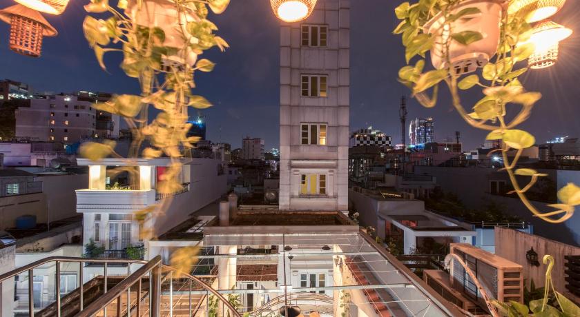 a clock tower in the middle of a city, The Like Hostel & Cafe in Ho Chi Minh City