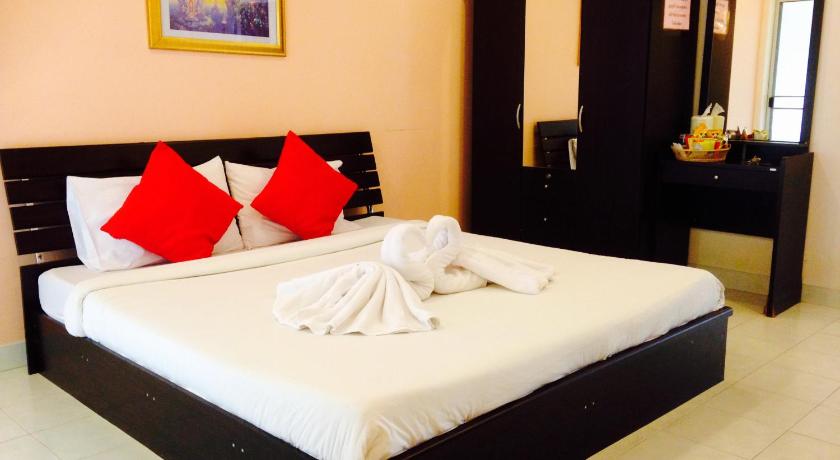 a hotel room with a bed and a dresser, Jaroonwej Bangsaen in Chonburi