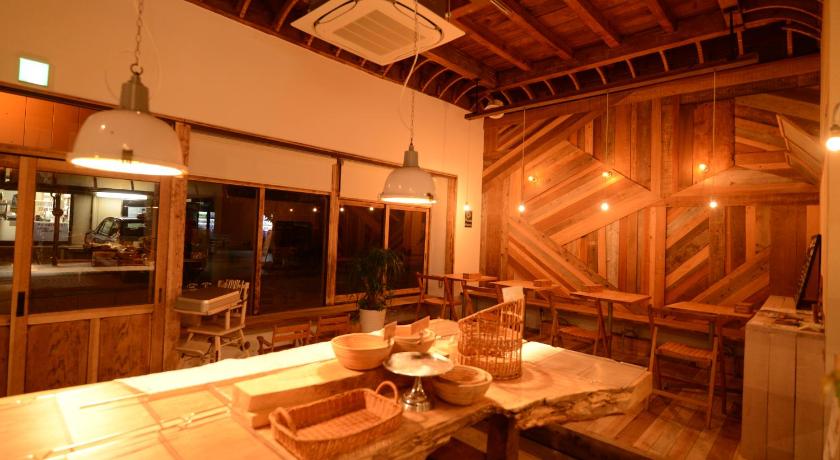 a dining room table with chairs and a large window, TAKETA Station Hostel cue in Kokonoe