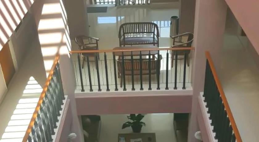a room filled with lots of furniture and a stair case, Hotel Amalia Malioboro in Yogyakarta