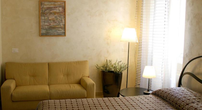 a hotel room with a couch, chair, lamp and a window, B&B Dolce Casa in Vasto