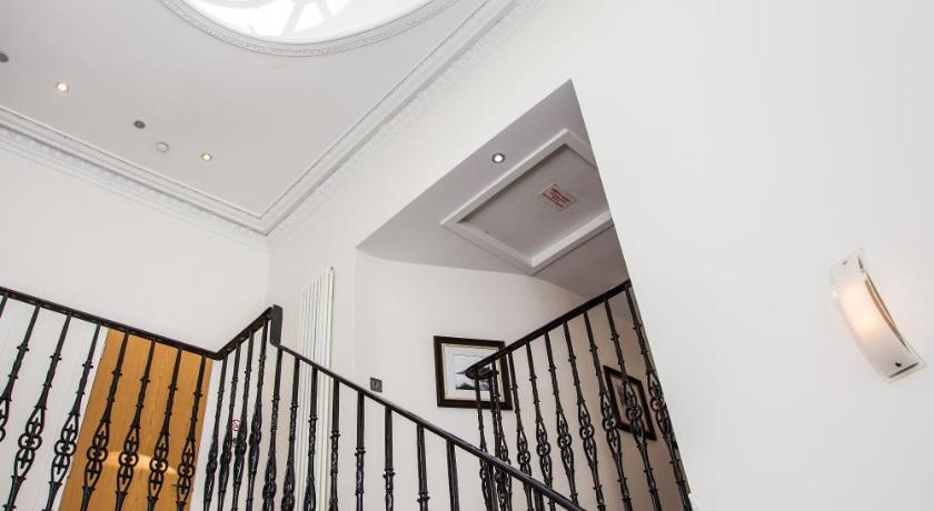 a staircase leading up to a room with a balcony, Blythswood Square Apartments in Glasgow