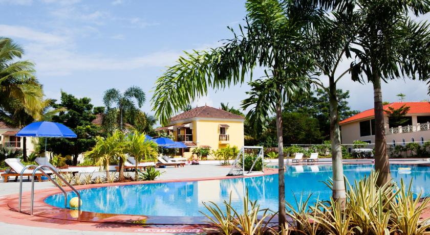 a beach with palm trees and palm trees, Radisson Blu Resort Goa Cavelossim Beach in Goa