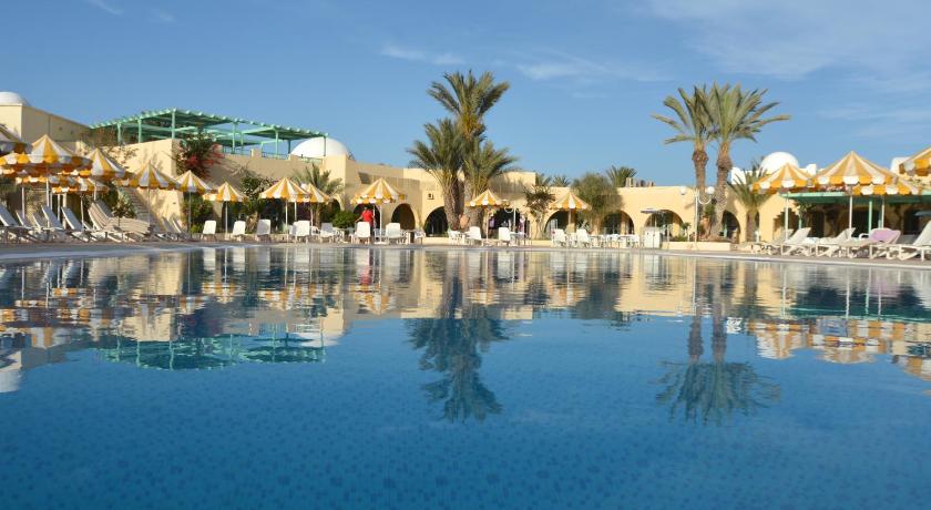 a large pool of water with palm trees, Venice Beach -Couples and Families Only in Djerba