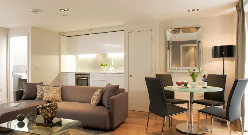a living room filled with furniture and a table, Fraser Residence City in London
