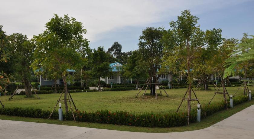 a grassy area with trees and houses, Poon Suk Resort Prachinburi in Prachinburi