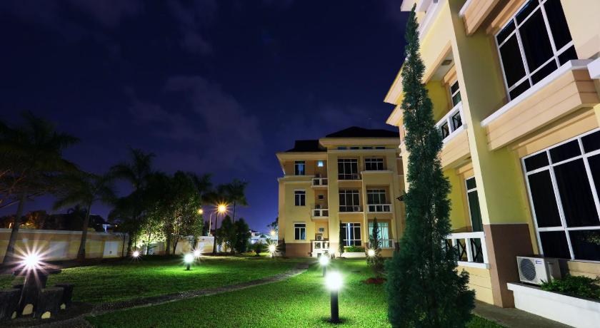 a large building with a clock on the side of it, Jinhold Service Apartment in Kuching