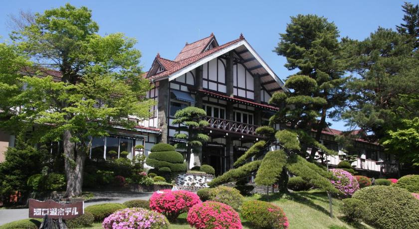 a large house with a large clock on the front of it, Kawaguchiko Hotel in Fujikawaguchiko