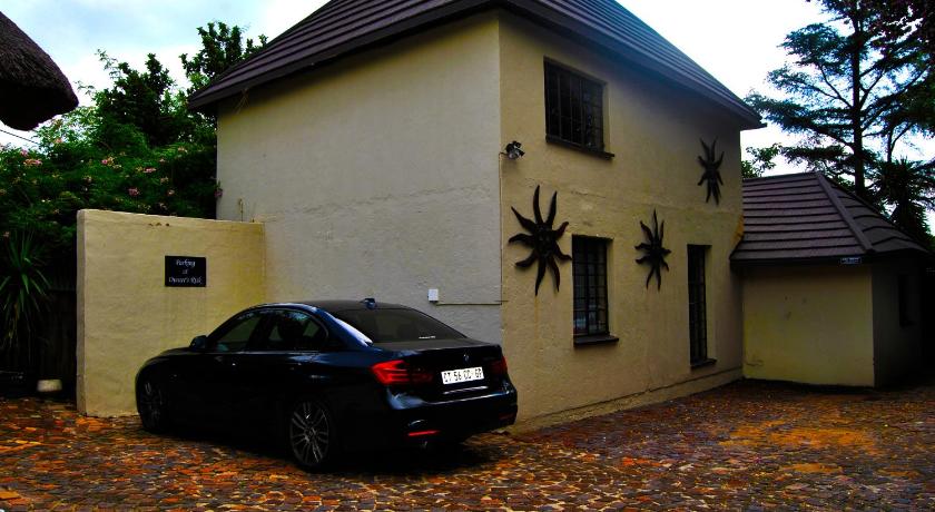 a car parked in front of a house, Birch Tree Cottage in Johannesburg