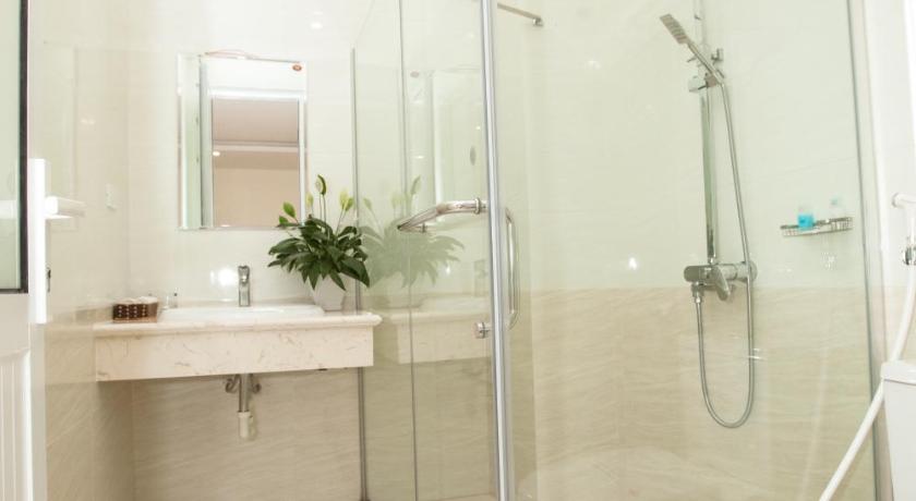 a bathroom with a shower, toilet and sink, Halong Seoul Hotel  in Hạ Long