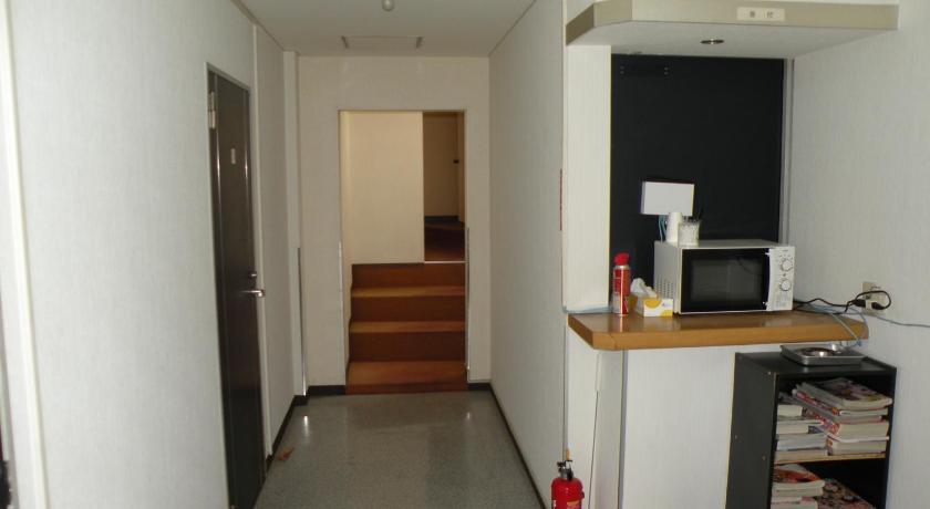 a room with a refrigerator, a sink, and a door, Business Hotel Minshuku Minato in Tokushima