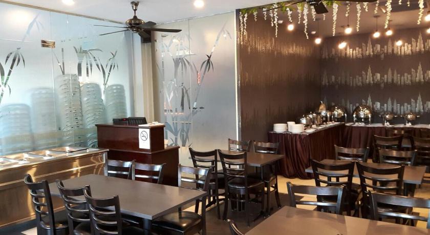 a restaurant with tables and chairs in it, Bary Inn KLIA in Kuala Lumpur