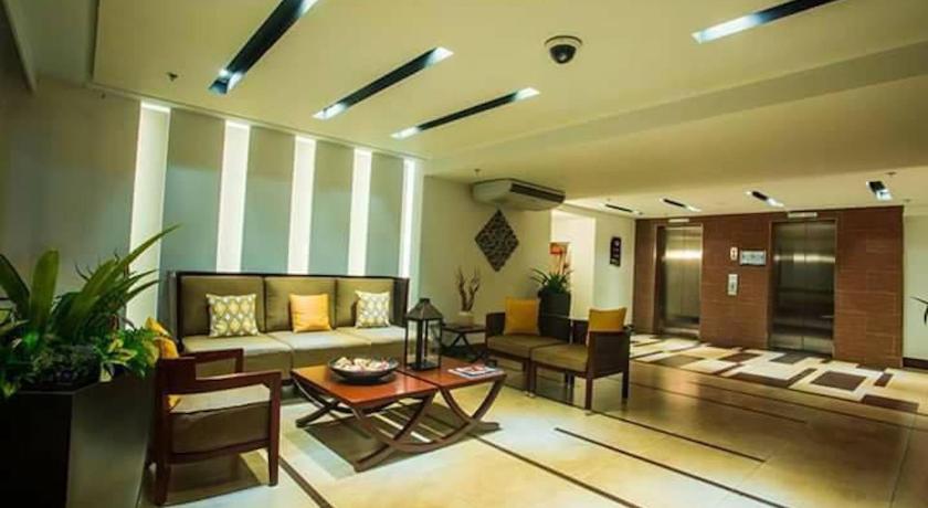 a living room filled with furniture and a large window, Boracay Oceanway Residences - Island Paradise in Boracay Island