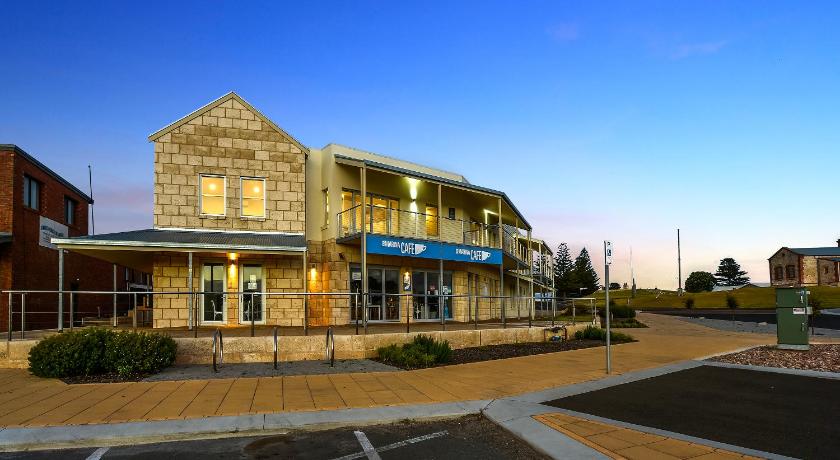 a large building with a clock on the front of it, Robe Marina Accommodation in Robe
