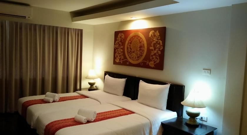 a hotel room with two beds and two lamps, Swankaburi Boutique Hotel in Sukhothai