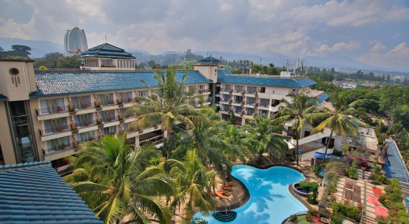 a beach with palm trees and palm trees, The Jayakarta Suites Bandung in Bandung