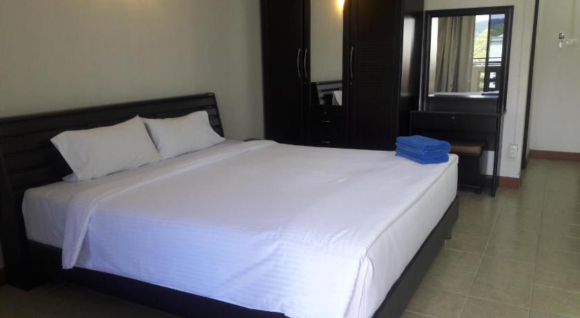 a hotel room with a bed and a television, mana residence in Hat Yai