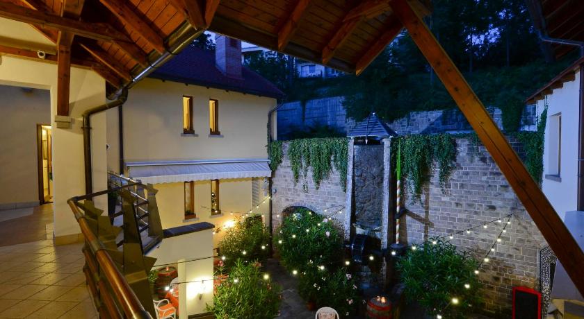a large room with a tree and a patio, Imola Udvarhaz Hotel in Eger
