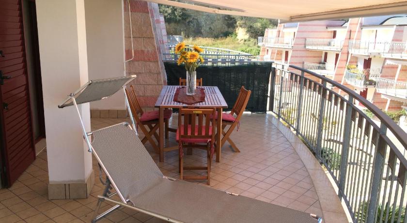 a patio area with a patio table and chairs, Lido delle Farfalle in Casalbordino