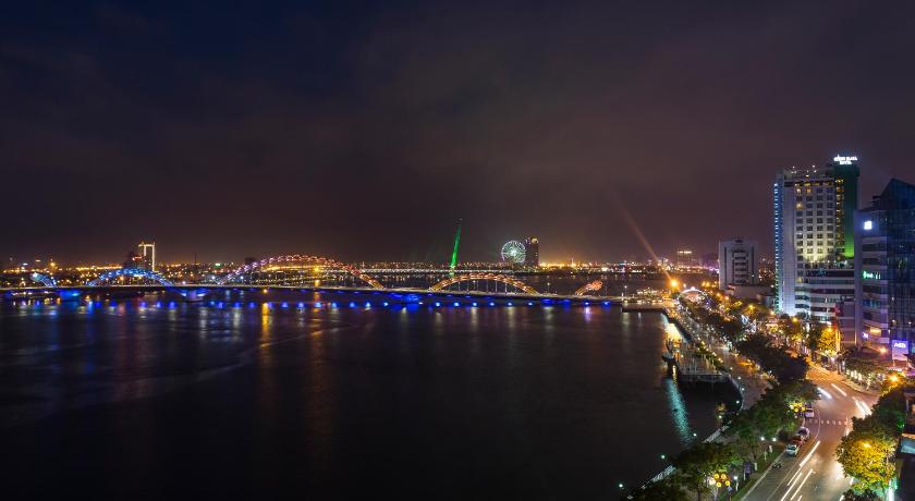 a city at night with a large body of water, Avora Hotel in Da Nang