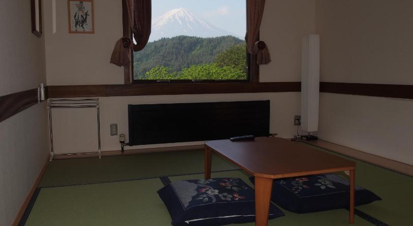 a room with a chair and a table in it, Guesthouse Sakuya in Fujikawaguchiko