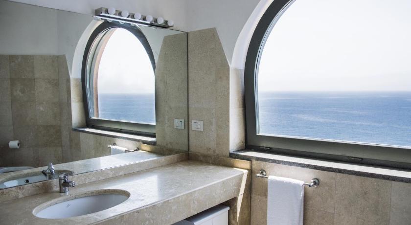 a bathroom with a sink and a mirror, Sunrise Guest House in Gaeta