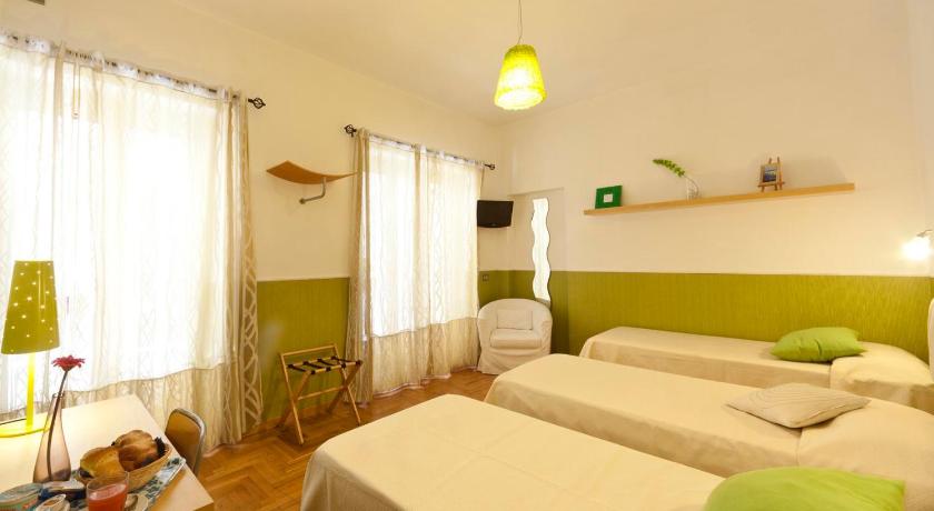 a bedroom with a bed, a desk and a lamp, B&B Cappella Vecchia 11 in Naples