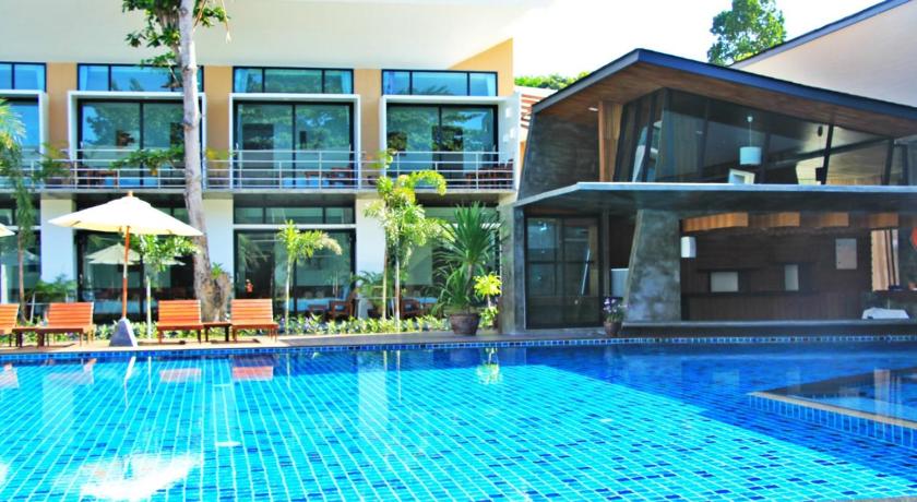 a swimming pool with a large swimming pool in front of a building, Bundhaya Resort in Ko Lipe