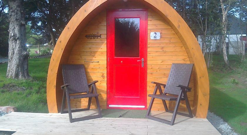 a wooden bench sitting in front of a wooden door, Dunvegan Camping Pods in Dunvegan
