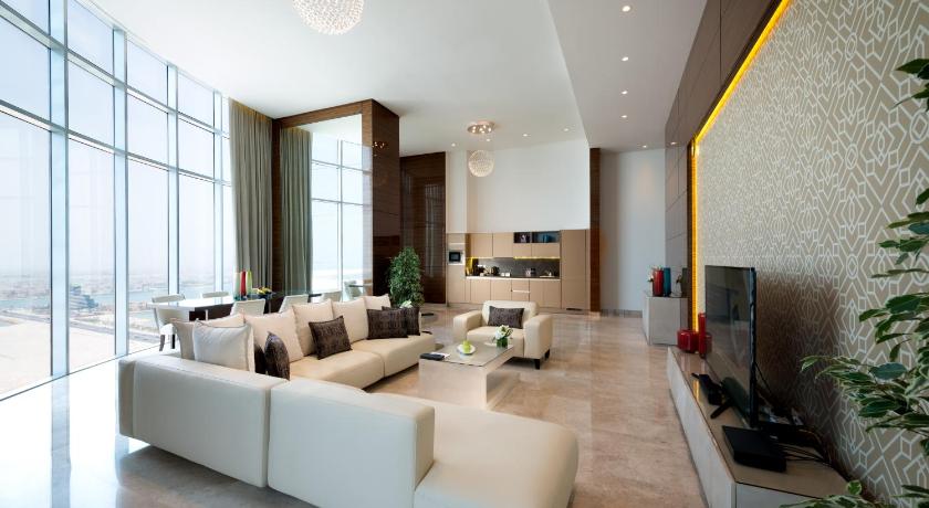 a living room filled with furniture and a tv, Fraser Suites Diplomatic Area Bahrain in Manama