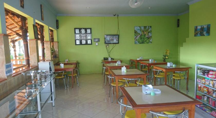 a kitchen filled with lots of tables and chairs, Cerah Hotel in Paiton