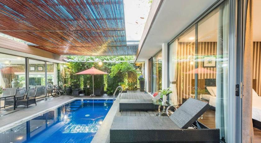 a swimming pool with a balcony and a large window, Flamingo Villa Happy in Phuc Yen