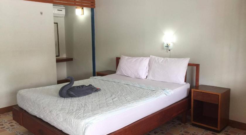a bedroom with a bed and a dresser, Scenery Guest House in Ko Phi Phi