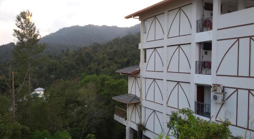 a large wooden building with a view of a mountain range, Genting Sempah Berjaya Hill in Bentong