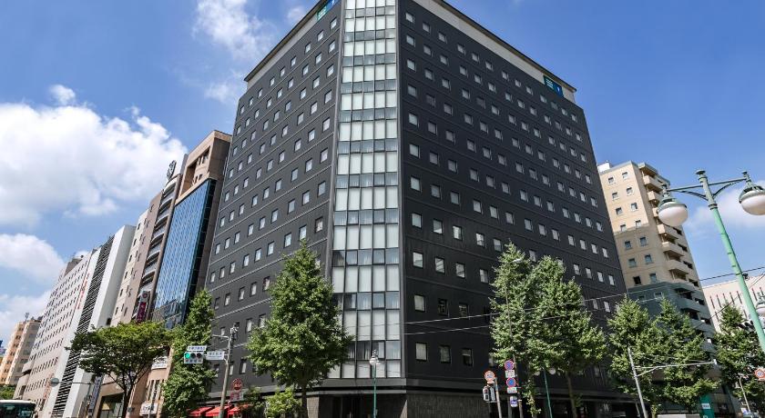 a tall building with a clock on the side of it, Hakata Green Hotel Building No.1 in Fukuoka