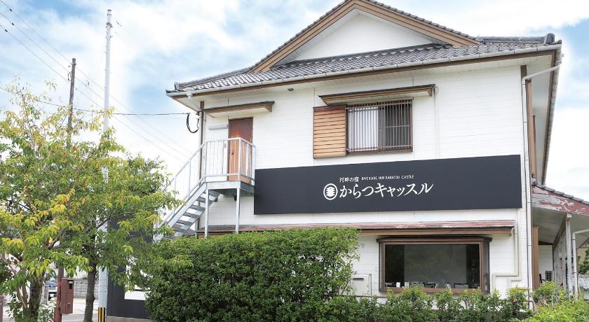 a white building with a sign on the front of it, Riverside Hotel Karatsu Castle in Karatsu