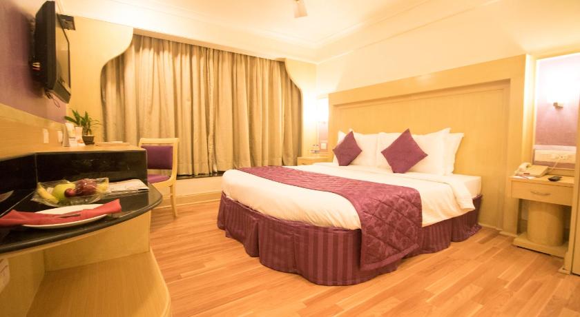 a hotel room with two beds and a table, VITS Mumbai International Airport T2 in Mumbai