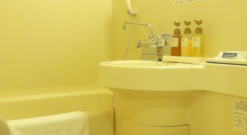 a white toilet sitting next to a white sink, Hotel Union in Kagoshima