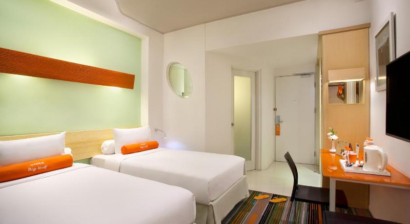 a hotel room with two beds and a television, HARRIS Hotel & Conventions Festival CityLink in Bandung
