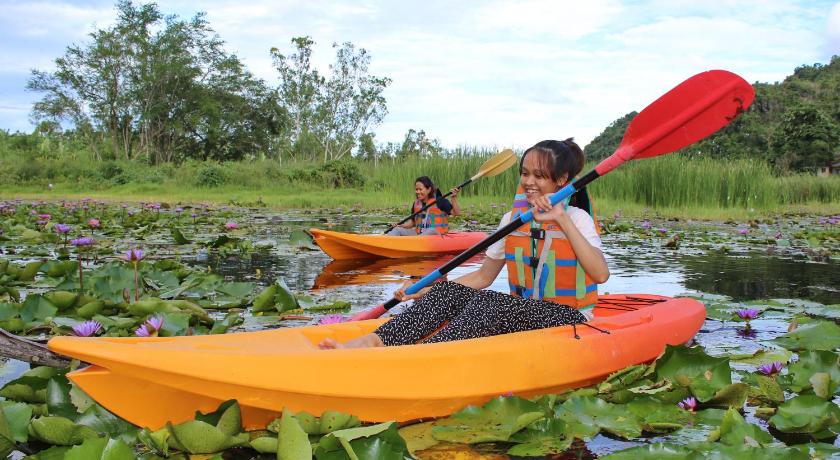 two people are paddling a kayak in the water, Baan Maka Nature Lodge in Phetchaburi