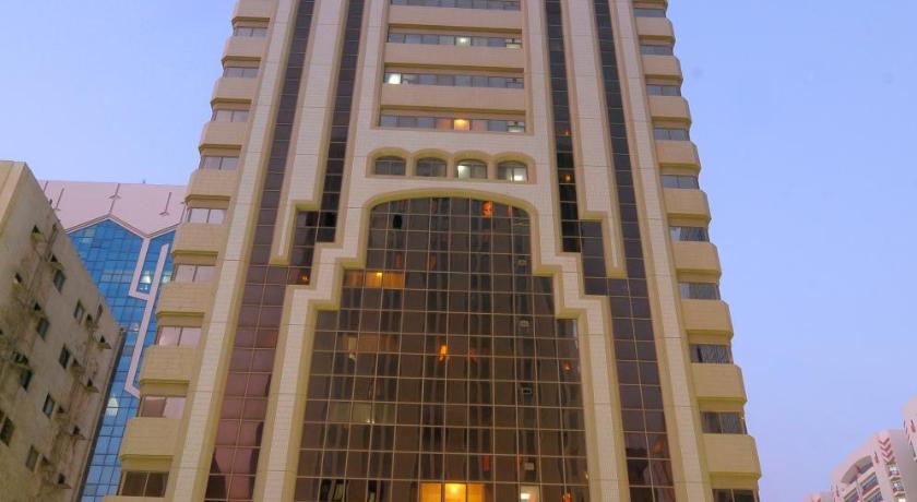 a large building with a clock on the top of it, Ivory Hotel Apartments in Abu Dhabi
