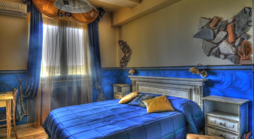 a bedroom with a bed and a painting on the wall, Guest House Qui Dormi L'Etrusco in Canino