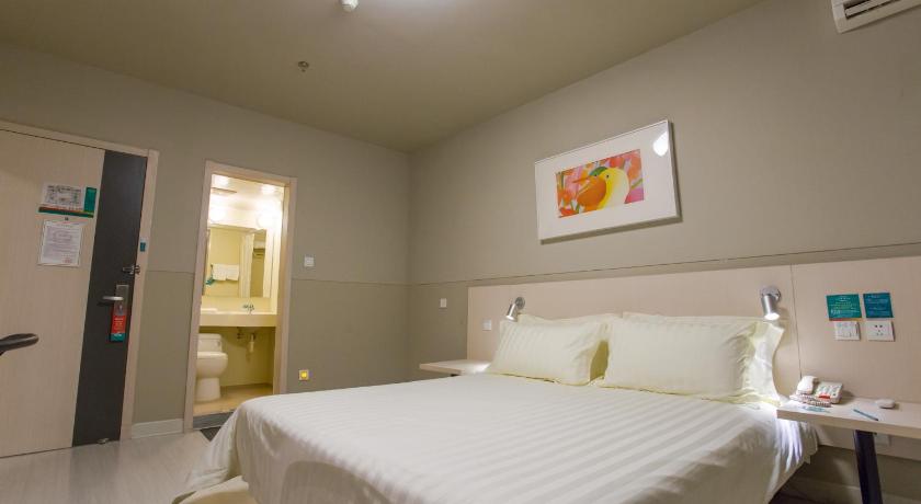 a hotel room with a white bed and white walls, Jinjiang Inn Beijing Xisi Branch in Beijing