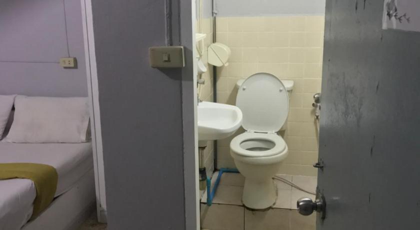 a bathroom with a toilet and a sink, Scandalic Bar and Guest house in Pattaya