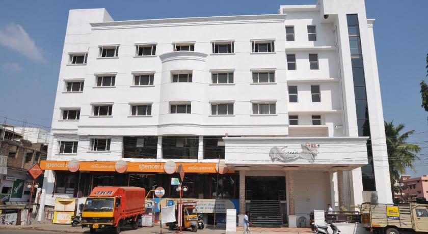 a large white truck parked in front of a building, Hotel Vijayentra in Pondicherry