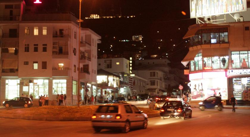 a city street filled with lots of traffic at night, Eden Hotel in Gjirokaster