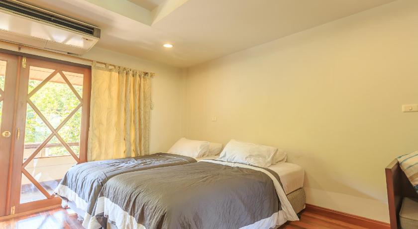 a bedroom with a bed and a dresser, Phuripimarn Penthouse in Khao Yai