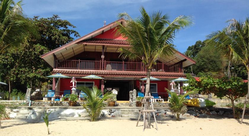 a beach house with a patio area with chairs and umbrellas, Sea Breeze House, Naiplao Beach in Nakhon Si Thammarat