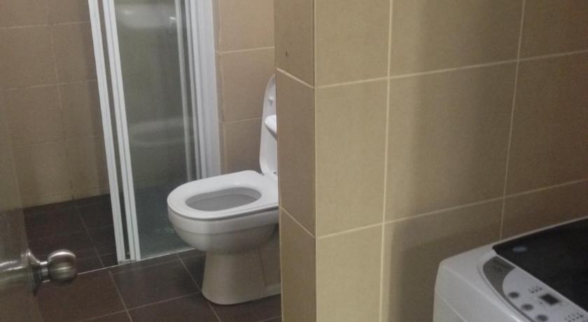 a white toilet sitting next to a shower in a bathroom, Obsom Suites at Taragon KL in Kuala Lumpur