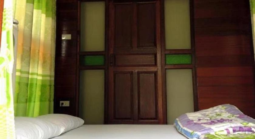 a bedroom with a bed and a window, Sarocha Resort Rayong in Rayong